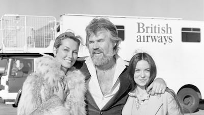 American singing star Kenny Rogers at London's Heathrow airport with his bride of a few weeks, television star Marianne Gordon (left) and Crystal Gayle. REUTERS