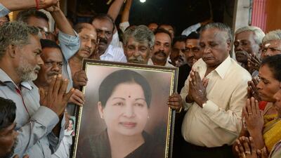 Supporters holding a photograph of Tamil Nadu state leader Jayalalithaa Jayaram as they offer prayers for her well being at a temple in Mumbai on December 5, 2016. The ailing chief minister of southern India's Tamil Nadu state suffered a cardiac arrest. Indranil Mukerjee/AFP