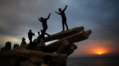 Palestinians spend their free time in the Gaza port during a sunset in the west of Gaza City on January 26, 2014. Many Palestinian people spend their free time in Gaza port after Hamas naval forces allowed Palestinian civilians daily access to the site. Mohammed Saber / EPA
