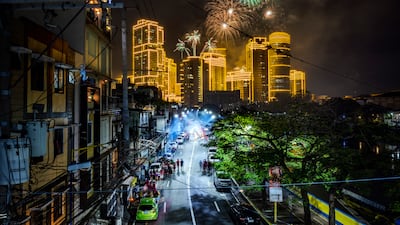 Fireworks explode over buildings during celebrations in Makati, Philippines. Getty