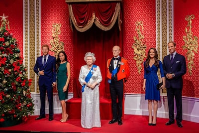 Wax figures of Prince Harry, the Duchess of Sussex, the Queen, Prince Philip, the Duchess of Cambridge and Prince William. Alamy