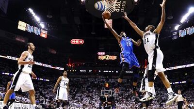 Kevin Durant goes to the basket against San Antonio Spurs player Tim Duncan.