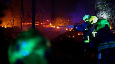Firefighters work at the scene of a wildfire in the Gironde department of Bordeaux, France, on Sunday. Reuters