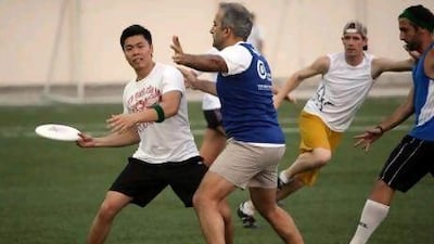 Participants of an ultimate frisbee league play a final game at the American Community School in Abu Dhabi.