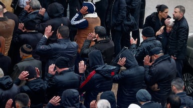 Mourners pray during the funeral of victims of the mosque attack in Homs. AP