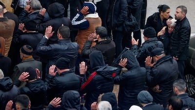 Mourners pray during the funeral of victims of the mosque attack in Homs. AP