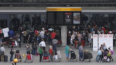 Passengers queue outside Terminal 3 at Heathrow Airport in London. Sang Tan / AP Photo