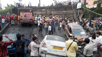 Firefighters and rescue workers continue their search for victims at the site. Reuters