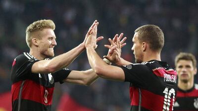 Germany midfielder Andre Schurrle celebrates scoring against Cameroon on Sunday with teammate Lukas Podolski as the Germans prepare for the 2014 World Cup in Brazil. Ralph Orlowski / Reuters / June 1, 2014