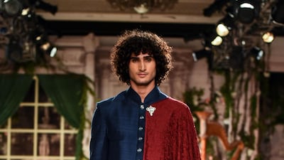 Designer Anju Modi reinterpreted the traditional dupatta as a superhero cape in her menswear line. AFP