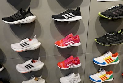 Shoes line a wall in an Adidas store in Miami, Florida. Reebok has been formally on the block since early this year after Adidas had tried for more than a decade to revive the brand’s performance. Photo: Getty Images/AFP