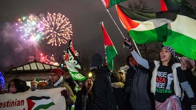 New Year's Eve fireworks go off in the sky as pro-Palestinian supporters protest in Boston, Massachusetts. AFP