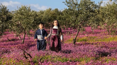 Syrian Kurd children hold each other's hands as they prepare to celebrate the spring festival of Nowruz, in Afrin, Syria. Reuters