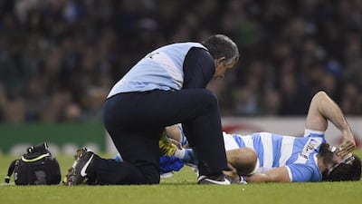 Argentina’s Juan Martin Fernandez Lobbe receives medical attention after sustaining injury. Rebecca Naden / Reuters