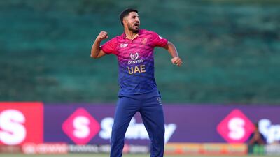 UAE's Junaid Siddique celebrates taking the wicket of Oman's Aamir Kaleem