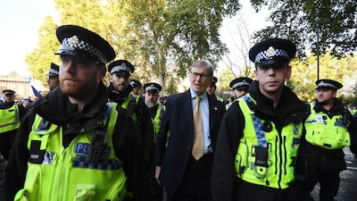 Brexiter and Member of Parliament, Bill Cash (C) leaves the Houses of Parliament escorted by police. EPA