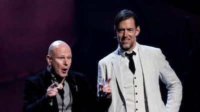Inductees Philip Selway, left, and Ed O'Brien of Radiohead speak onstage. REUTERS