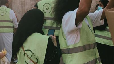 Volunteers gather boxes containing essential supplies, such as cooking oil, rice and sugar.