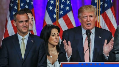 Republican presidential candidate Donald Trump's campaign manager, Corey Lewandowski (L), looks on as Mr Trump (C) speaks at an election campaign event in Palm Beach, Florida on March 15, 2016, after winning the state's Republican primary. Erik S Lesser/EPA
