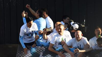 Manchester City backroom staff celebrates on the team bus during the Manchester City Teams Celebration Parade in Manchester, England. Getty Images