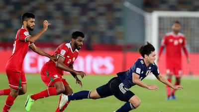 Takumi of Japan is tripped by Al Mahaijri and Salaah Al Yahyaei of Oman. Chris Whiteoak / The National