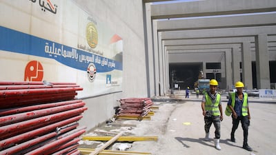 Labourers walk near the entrance to one of the new tunnels. EPA