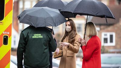 Catherine, Duchess of Cambridge talks with ambulance crew. AP Photo