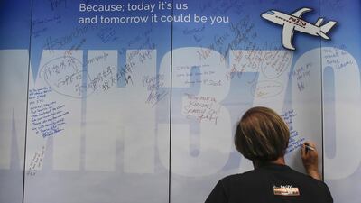 The news that the search for MH370 has been suspended must have compounded the families' grief. Fazry Ismail / EPA