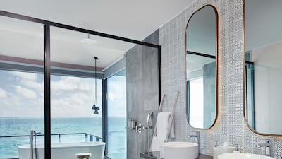 Bathrooms feature his and hers sink, a free-standing bath and ocean views.