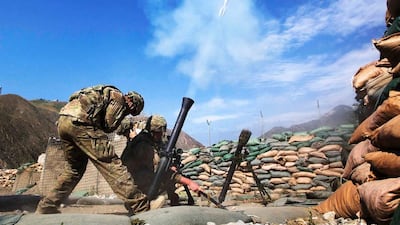 Private First Class Trent Pritchartt (L), Specialist Lance Doan (C), and Specialist Ben Purvis from the mortar platoon on Combat Outpost Nangalam fire 81mm mortar rounds at suspected insurgent positions in the Pech River Valley of Afghanistan's Kunar Province June 28, 2012. REUTERS/Lucas Jackson (AFGHANISTAN - Tags: CIVIL UNREST MILITARY)