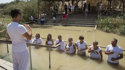 A group of deaf Russian immigrants use sign language as they hold a ceremony and visit the Jordan River at the Qasr Al Yahud baptism site on the West Bank side of the river. Christian worshippers believe the site is where John the Baptist baptised Jesus is located. The Jordanian side of the river is seen in the background.