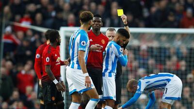 Huddersfield Town's Elias Kachunga is shown a yellow card by referee Jonathan Moss. Action Images via Reuters