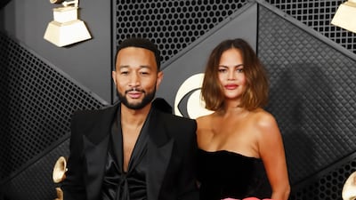 John Legend wears a black tuxedo with a silk blouse and Chrissy Teigen wears Alexandre Vauthier Couture. EPA
