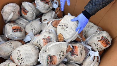 Turkeys are given to residents at a food distribution event ahead of the Thanksgiving holiday in Brooklyn, New York City. AFP