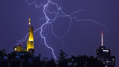 Lightning over the headquarters of Commerzbank, left, and Helaba in Frankfurt, central Germany. Frank Rumpenhorst / dpa via AP