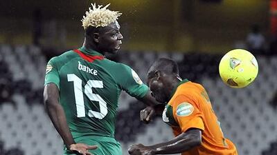 Burkina Faso's former Al Ahli forward Aristide Bance battles for the ball against Zambia's Isaac Chansa.
