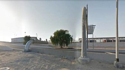 The distance between the warning sign with the hanging chain and the protruding barrier, that the driver crashed the bus into. Google Maps
