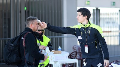 Staff at the San Siro stadium check the temperature of a photographer ahead of the AC Milan v Genoa match. Reuters