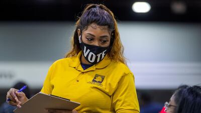 Officials with the Fulton County Registration and Elections Department conduct a machine recount of the county's presidential election ballots. EPA