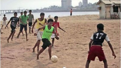 Indian children play football in Mumbai. AP Photo