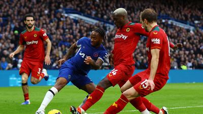 Chelsea's Raheem Sterling vies for the ball with Wolves' Toti and Craig Dawson. Reuters