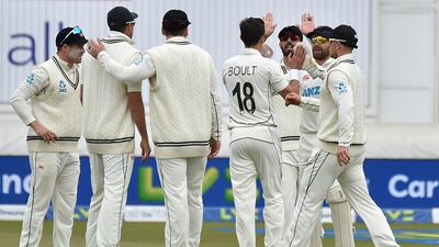 New Zealand bowler Trent Boult celebrates with teammates after the dismissal of England's Joe Root. AP
