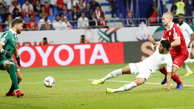 Hussain Al Moqahwi, centre, of Saudi Arabia scores against Lebanon. EPA