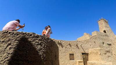 Egyptians pose for a picture in front of the oldest mosque in Egypt's Western Desert in Siwa Oasis, west of the Egyptian capital, Egypt. Reuters