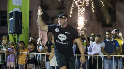 A contestant from Russia waves to the crowd at the World's Ultimate Deadlift, Burj Plaza, Dubai.