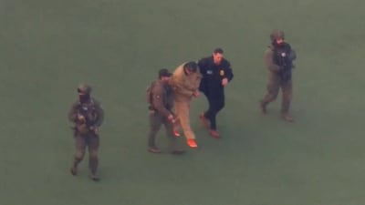 Mr Maduro being moved from a vehicle to a helicopter. Reuters