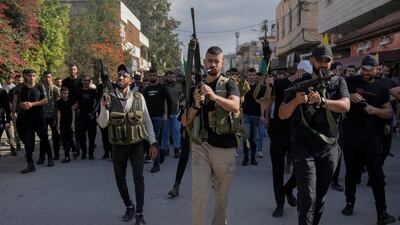 Gunmen attend the funeral of Palestinians killed in an overnight Israeli army raid, in the Jenin refugee camp. AP