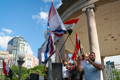 Fans wave Iraqi and Assyrian flags. Joshua Longmore / The National