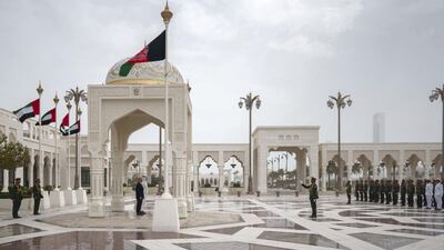 Sheikh Mohamed and Mr Ghani stand for the national anthem during a reception at the Presidential Palace.