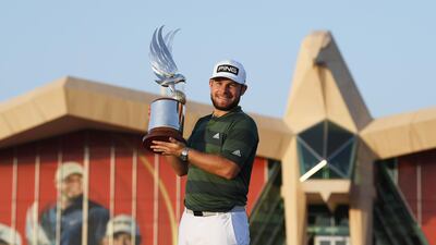 Tyrrell Hatton of England celebrates with the trophy following victory at the 2021 Abu Dhabi HSBC Championship. Getty
